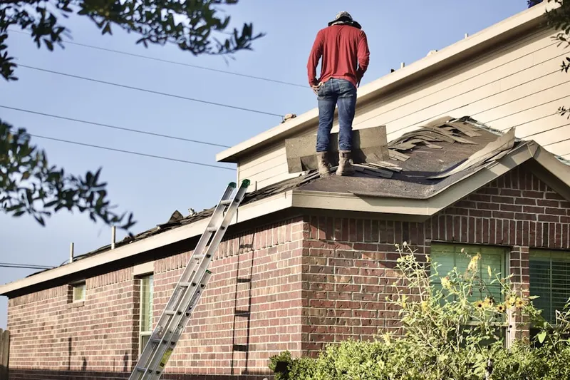 Professional roofer working on a residential roof in Superior